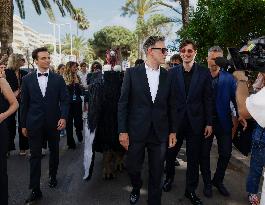Cannes Raphael Quenard, Francois Civil, Michel Hazanavicius walk with condor from Hotel Martinez MP