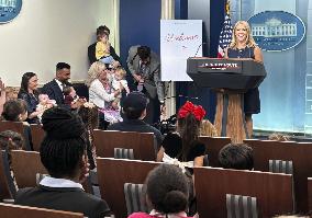 White House press secretary meets children in briefing room