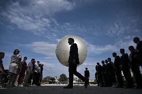 Macron Visits The Olympic Cauldron Reinstallation Site - Paris