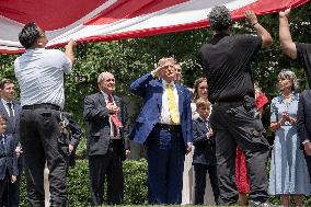 U.S. President Donald Trump Watches as the American Flag is Raised ont he South Lawn