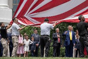 U.S. President Donald Trump Watches as the American Flag is Raised ont he South Lawn