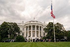 U.S. President Donald Trump Watches as the American Flag is Raised ont he South Lawn