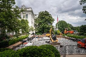 Workers reconstruct the Rose Garden from grass to pavement at White House