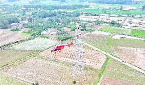 Helicopters Conduct Aerial Patrols on Ultra-high Voltage Transmission Lines