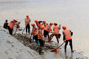 Clearing Silt After Flood in Rong'an