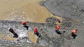 Clearing Silt After Flood in Rong'an