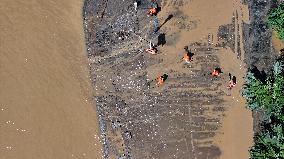 Clearing Silt After Flood in Rong'an