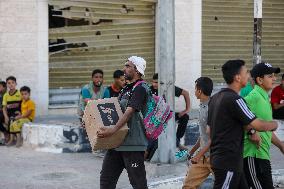 Palestinians Carry Collected Tree Branches and Scrap Wood - Gaza