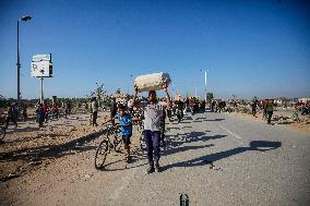 Palestinians Carry Collected Tree Branches and Scrap Wood - Gaza