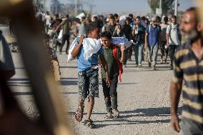 Palestinians Carry Collected Tree Branches and Scrap Wood - Gaza