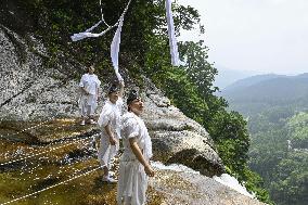 Sacred rope replaced at western Japan waterfall