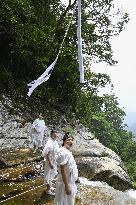 Sacred rope replaced at western Japan waterfall