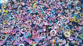 Tourists Enjoy Coolness in Water Park
