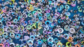 Tourists Enjoy Coolness in Water Park