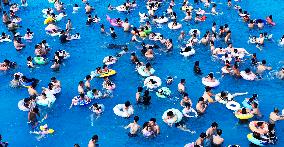Tourists Enjoy Coolness in Water Park