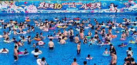 Tourists Enjoy Coolness in Water Park