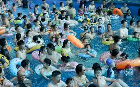 Tourists Enjoy Coolness in Water Park