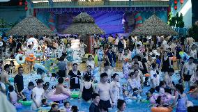 Tourists Enjoy Coolness in Water Park
