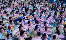 Tourists Enjoy Coolness in Water Park