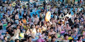 Tourists Enjoy Coolness in Water Park
