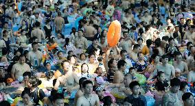 Tourists Enjoy Coolness in Water Park