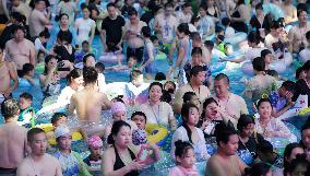 Tourists Enjoy Coolness in Water Park