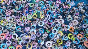 Tourists Enjoy Coolness in Water Park