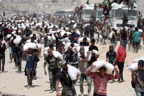 Palestinians Carry Flour As Humanitarian Aid Reaches Gaza