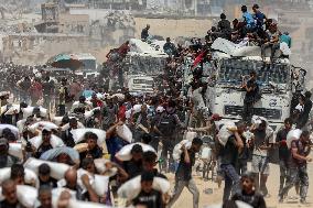 Palestinians Carry Flour As Humanitarian Aid Reaches Gaza