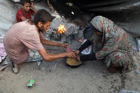 Displaced Family Prepares Meal Amid Food Shortages - Gaza City