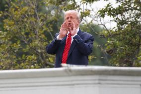 DC: President Trump walks on roof of the West Wing of the White House