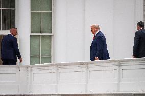 DC: President Trump walks on roof of the West Wing of the White House