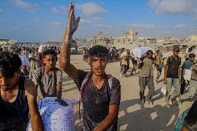 Palestinians Gather To Receive Limited Aid Amid Blockade - Palestine