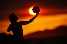 Illustration - Silhouetted at Sunset Amidst Vancouver Island Wildfires - Canada