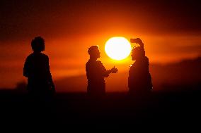 Illustration - Silhouetted at Sunset Amidst Vancouver Island Wildfires - Canada