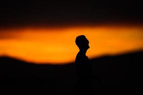 Illustration - Silhouetted at Sunset Amidst Vancouver Island Wildfires - Canada