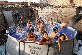 Boys Cool Off in A Pool During a Heatwave - Cairo