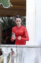 Lily Collins Takes a FaceTime Break during Emily in Paris Set - Venice