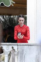 Lily Collins Takes a FaceTime Break during Emily in Paris Set - Venice