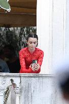 Lily Collins Takes a FaceTime Break during Emily in Paris Set - Venice