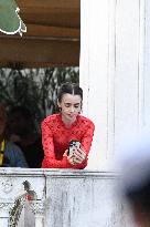 Lily Collins Takes a FaceTime Break during Emily in Paris Set - Venice