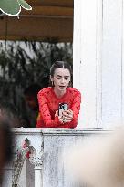 Lily Collins Takes a FaceTime Break during Emily in Paris Set - Venice