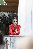 Lily Collins Takes a FaceTime Break during Emily in Paris Set - Venice