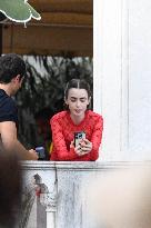 Lily Collins Takes a FaceTime Break during Emily in Paris Set - Venice