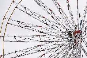 A Labourer Works on A Giant Ferris Wheel - India