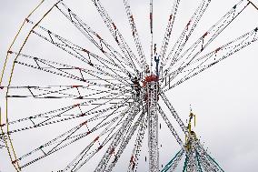 A Labourer Works on A Giant Ferris Wheel - India