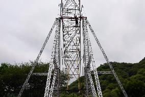 A Labourer Works on A Giant Ferris Wheel - India
