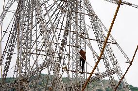 A Labourer Works on A Giant Ferris Wheel - India
