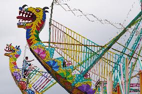 A Labourer Works on A Giant Ferris Wheel - India