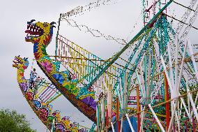 A Labourer Works on A Giant Ferris Wheel - India